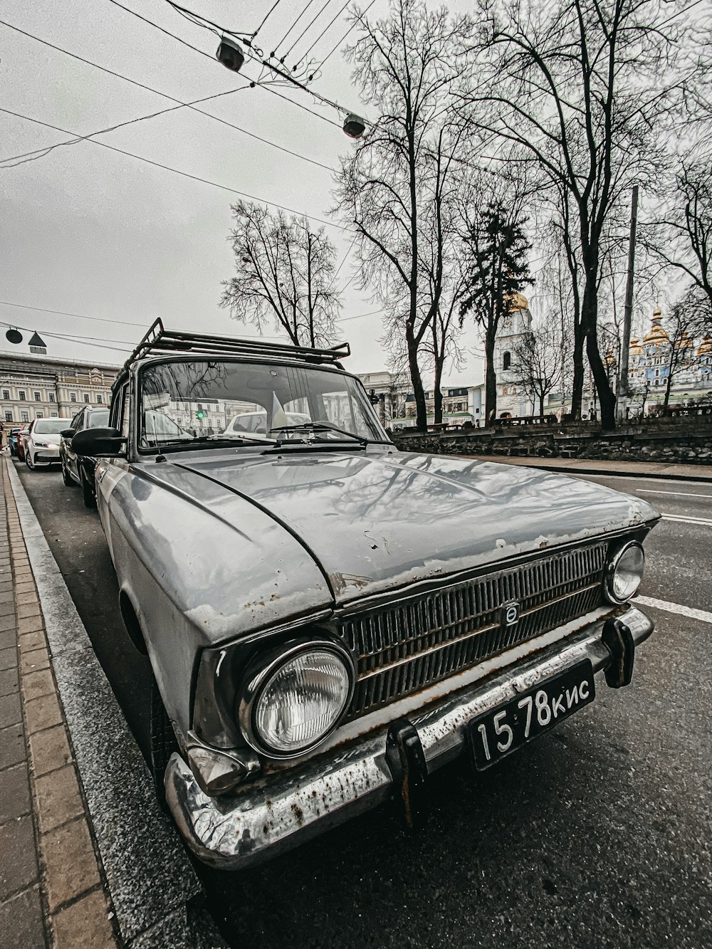 an old car parked on the side of the road