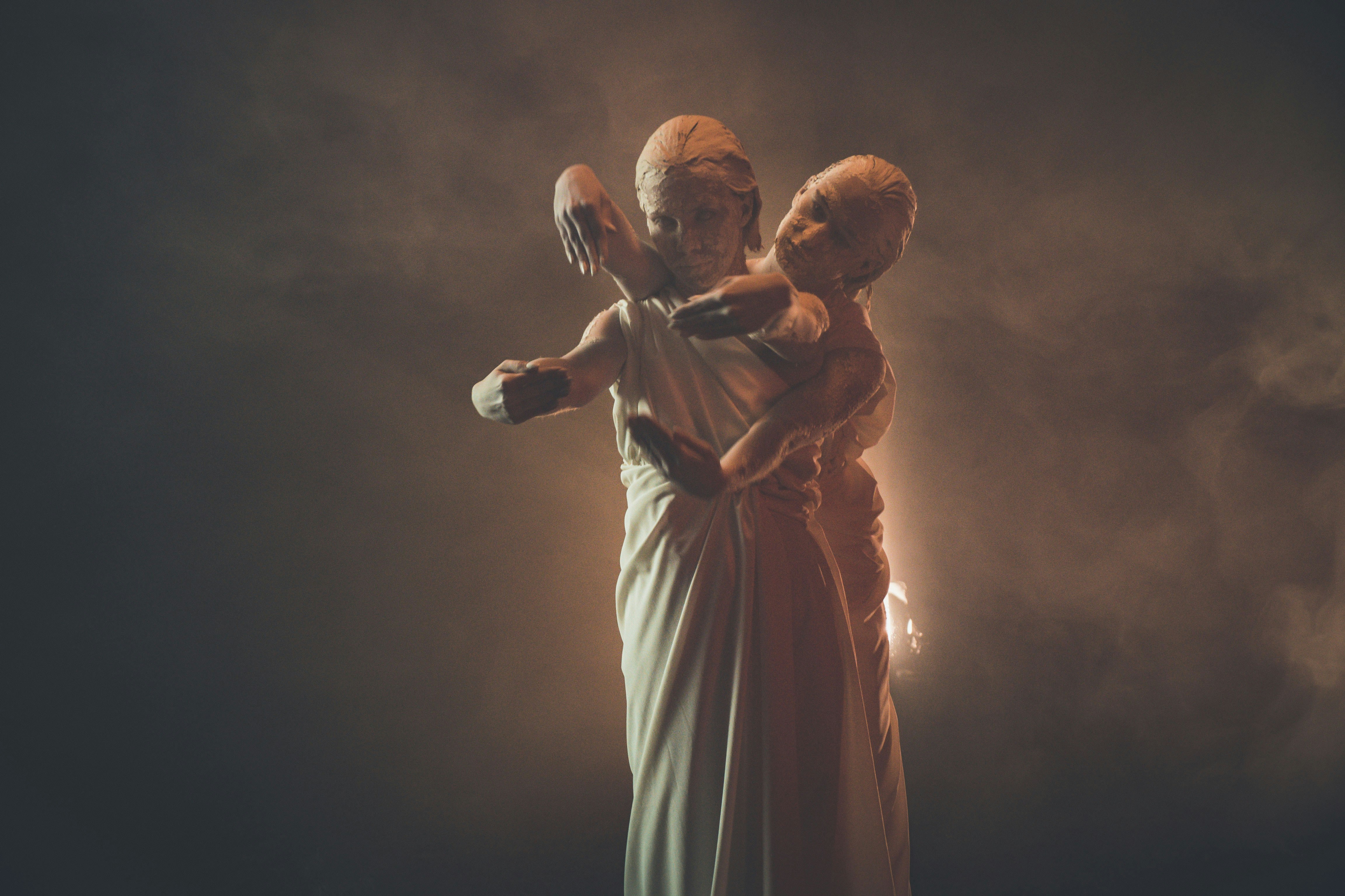 man in white thobe holding microphone