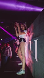 a woman in fishnet stockings dancing on a stage