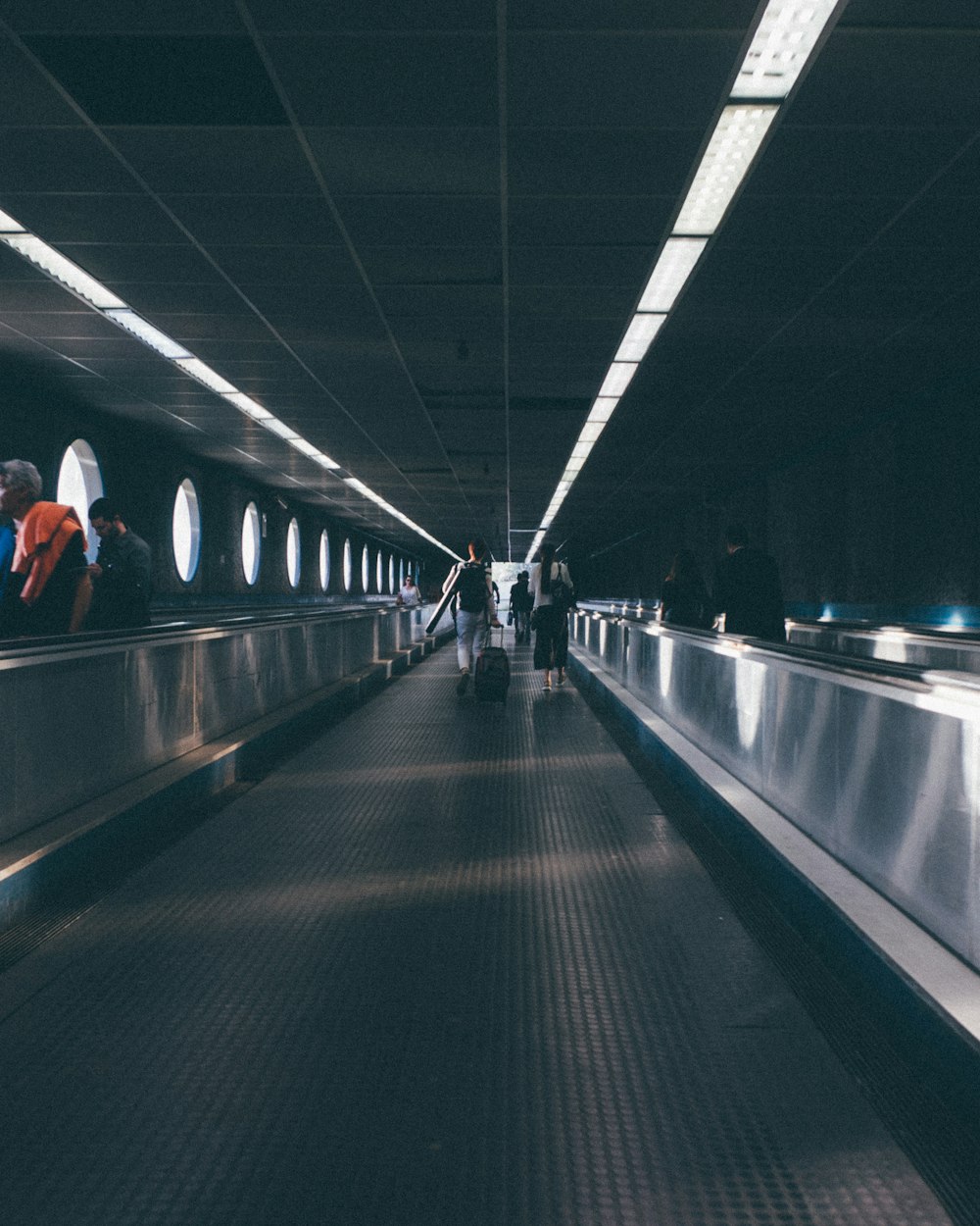 a group of people walking down an escalator