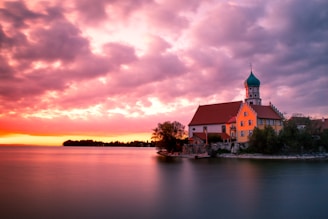 a church on a small island in the middle of a lake