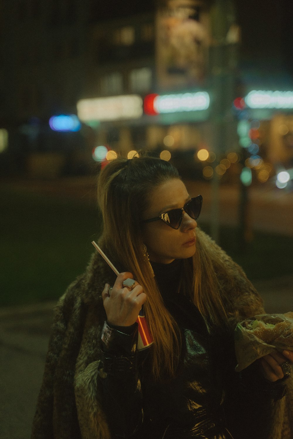 a woman smoking a cigarette on a city street