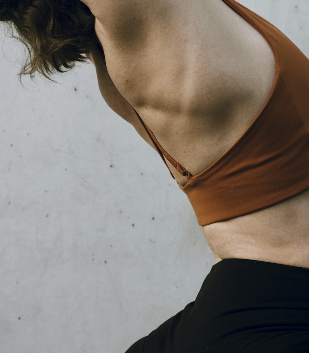 a woman in a brown top and black pants