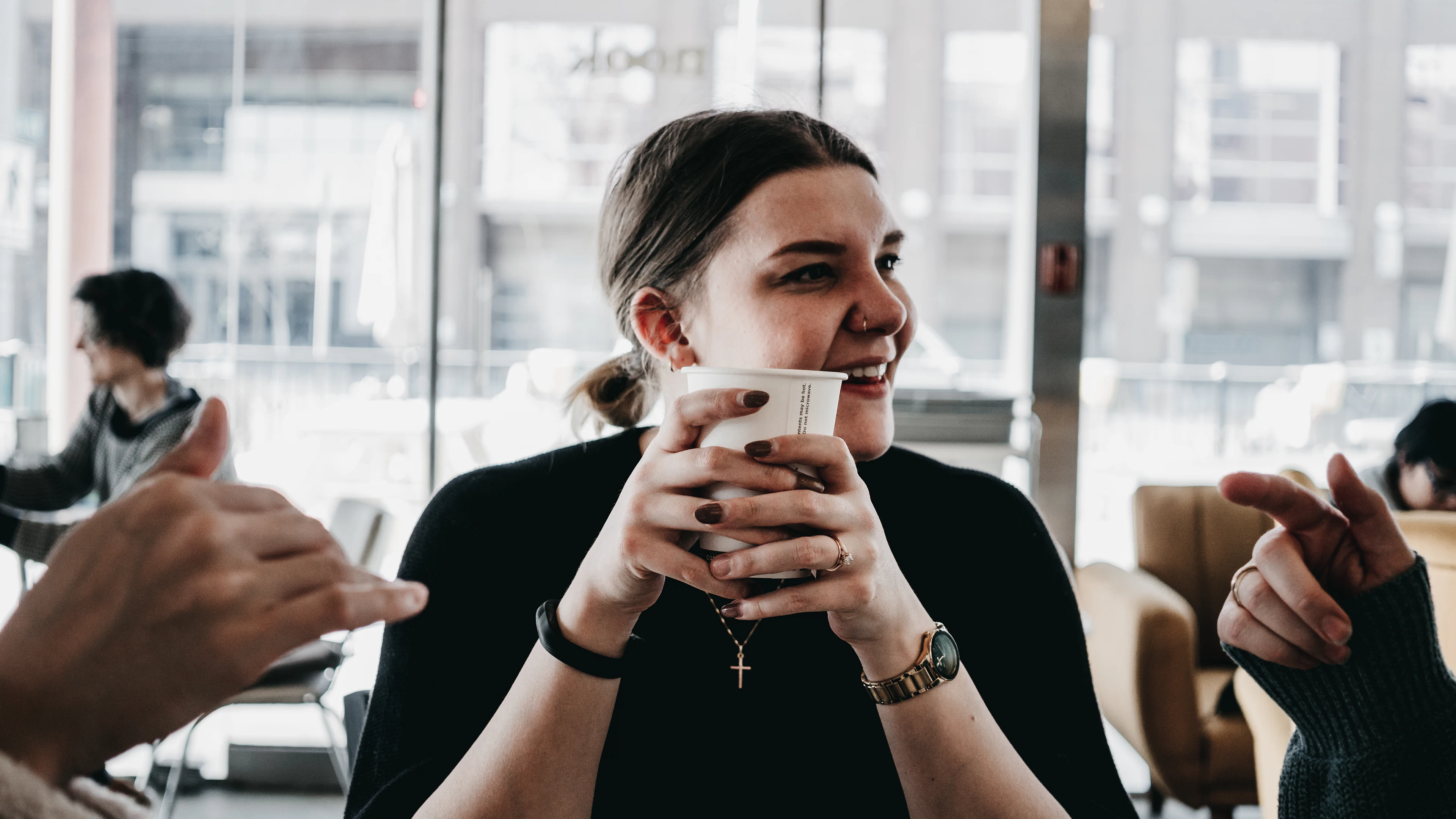 Woman smiling over her morning coffee