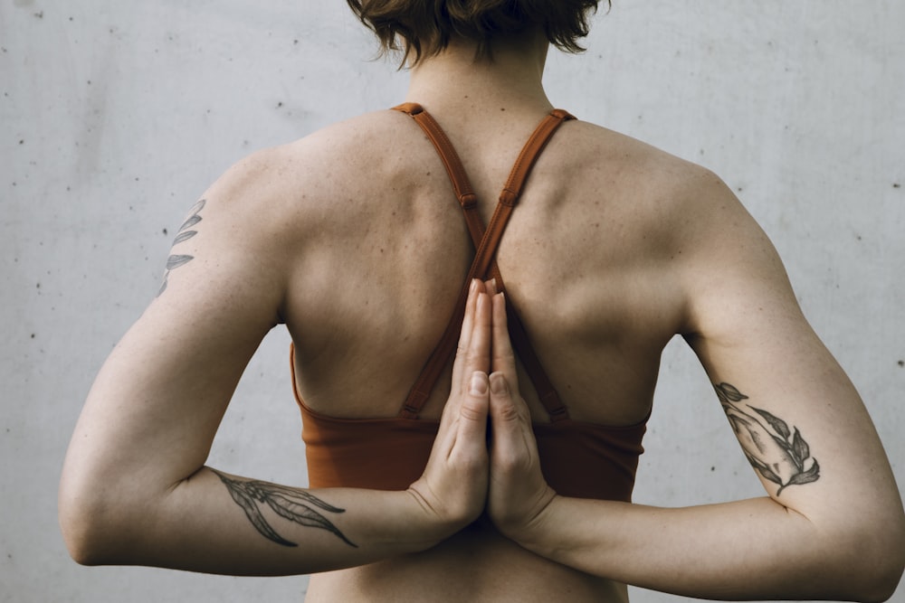 a woman in a bra top is doing yoga