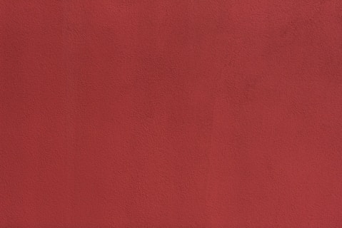 a close up of a red wall with a white background