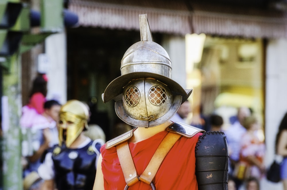 selective focus photography of man wearing gold and red costume