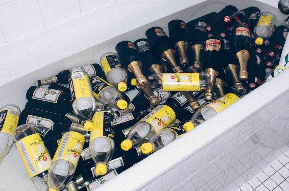 a tub filled with lots of bottles of beer