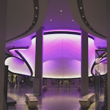 A sleek, modern office interior featuring royal purple accents and soft gold details.