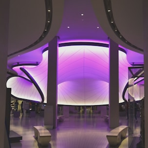 A sleek, modern office interior featuring royal purple accents and soft gold details.