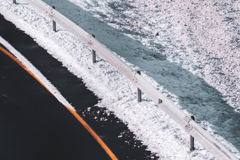 white metal railings on seashore during daytime