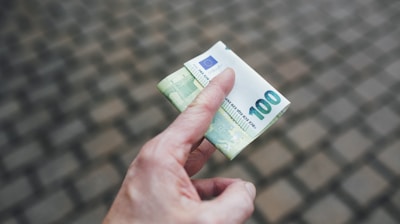 a person holding a piece of money in their hand