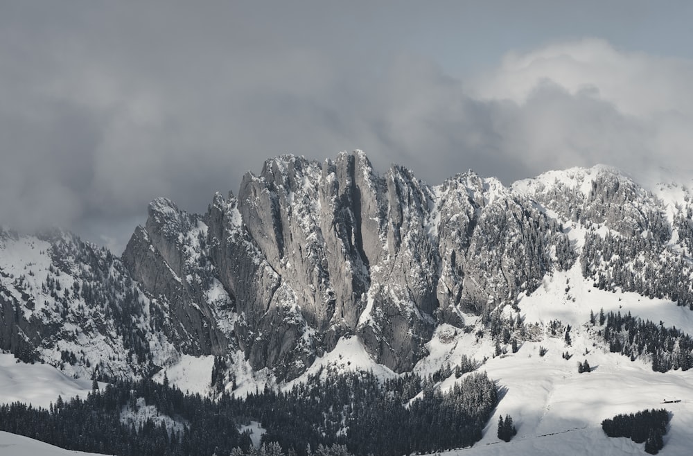 snow covered mountain under cloudy sky during daytime