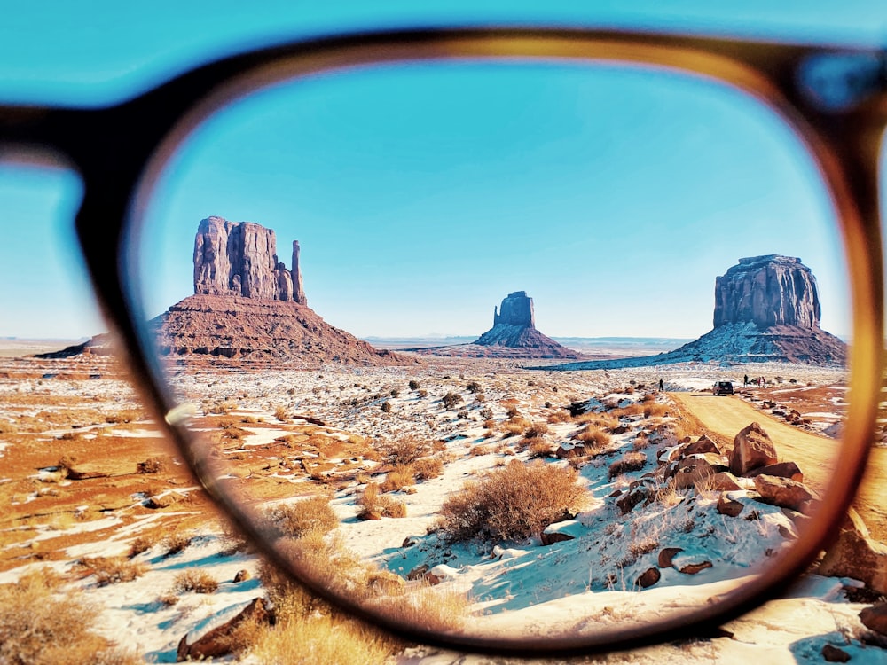 a pair of glasses sitting on top of a desert