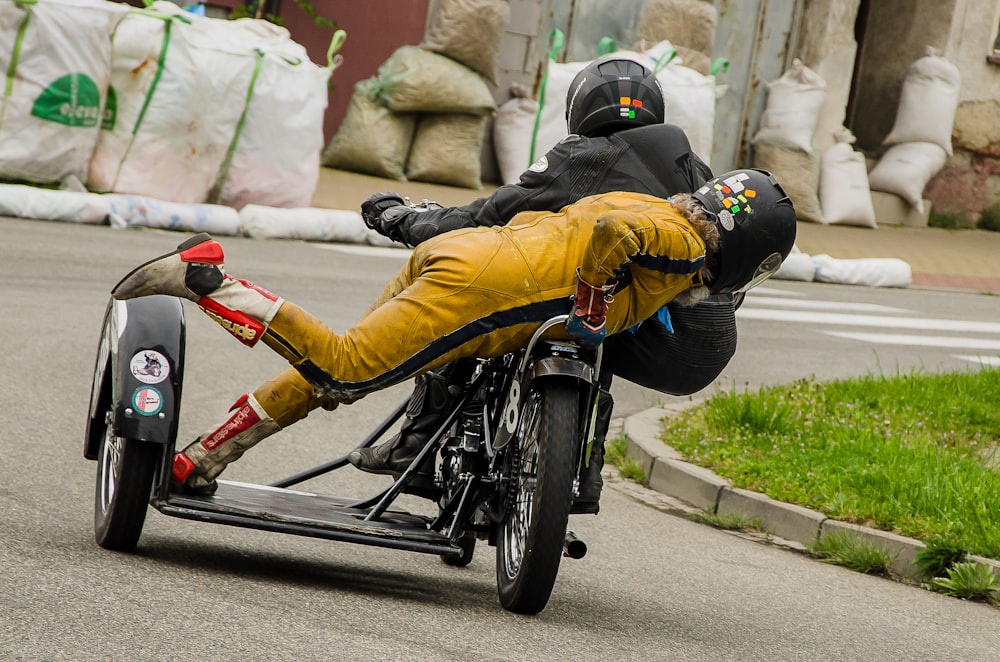 man in yellow jacket riding on black bicycle during daytime