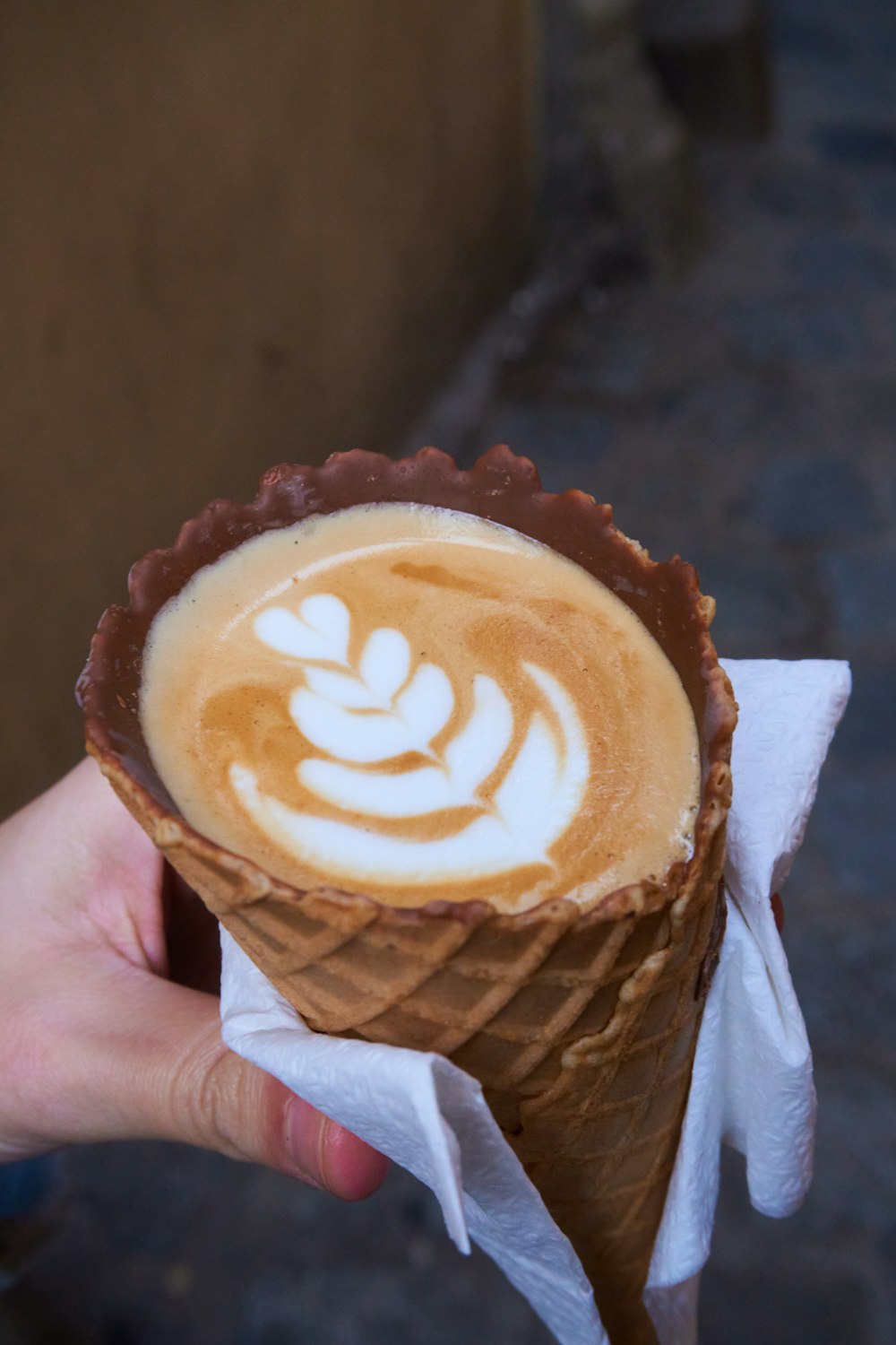 person holding brown and white coffee