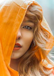 a woman with a yellow scarf over her head