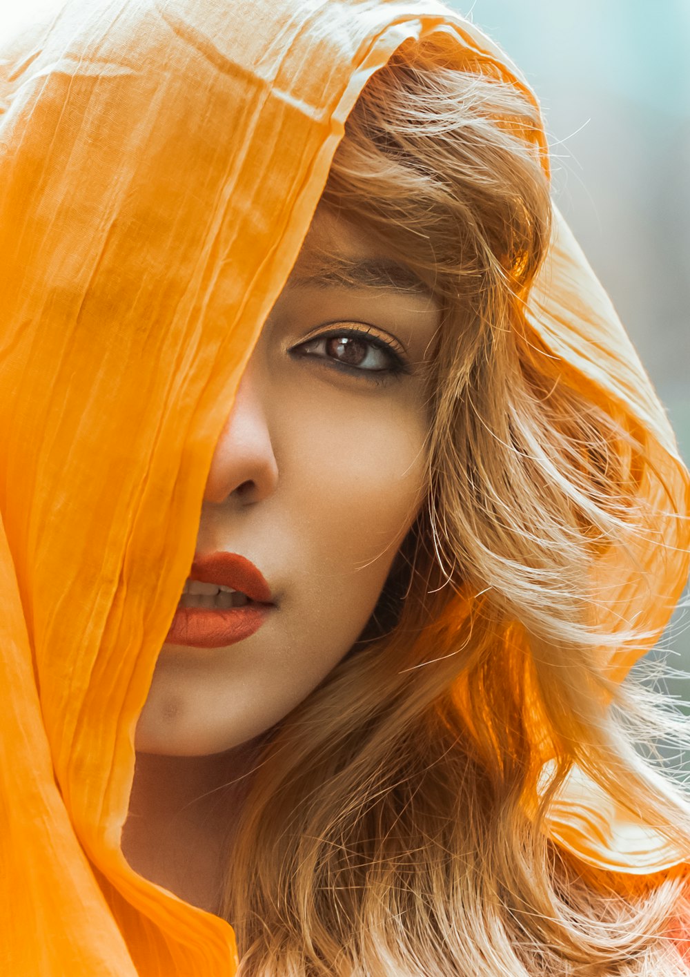 a woman with a yellow scarf over her head