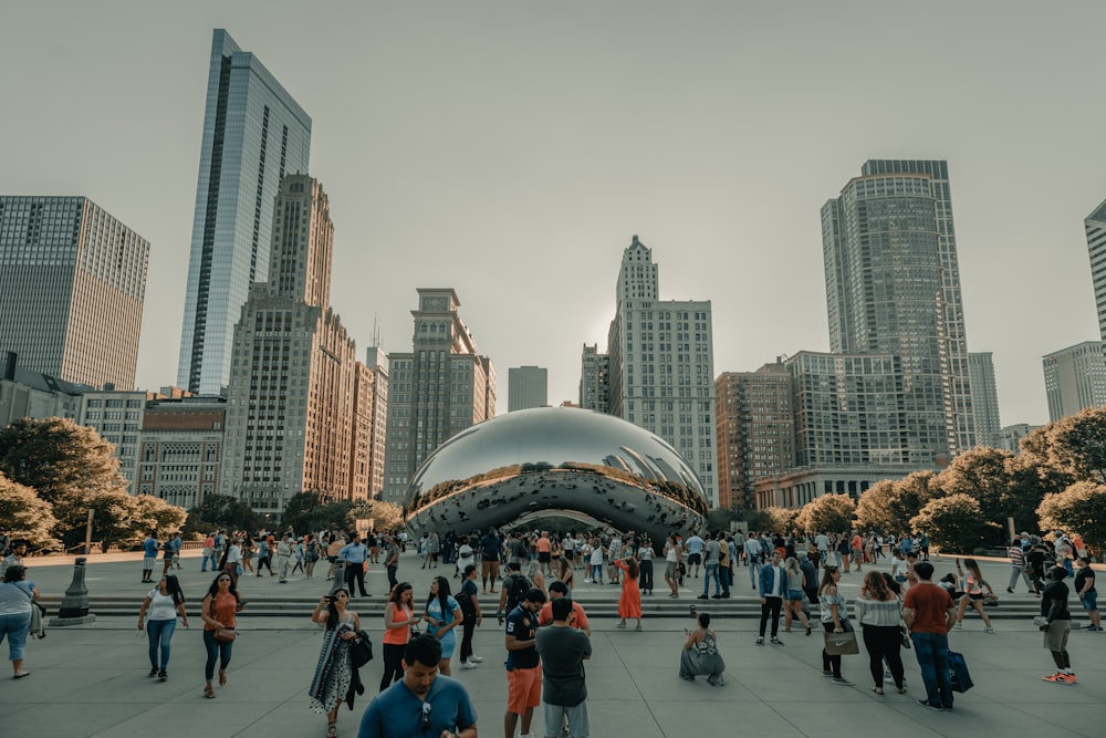 a large group of people standing around in a city