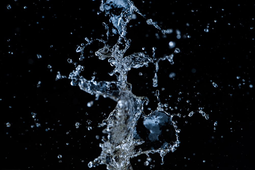 a black background with water splashing on it