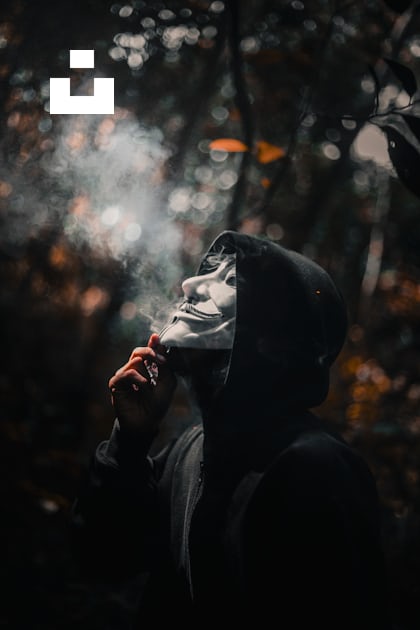 A person in a hooded jacket smoking a cigarette photo – Free Grey Image ...