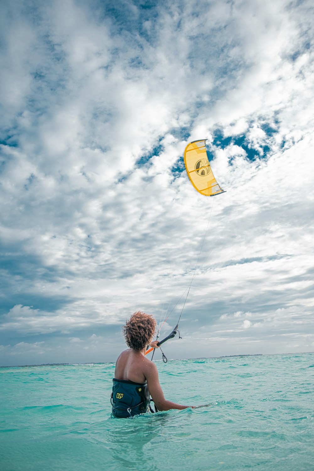 a person in the water with a kite