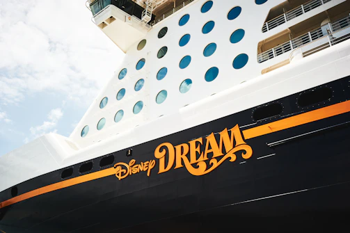 A personalized cruise door sign with family names and playful Disney characters.