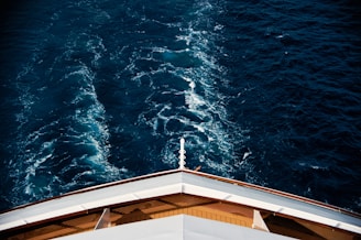 the view from the top of a ship looking down at the water