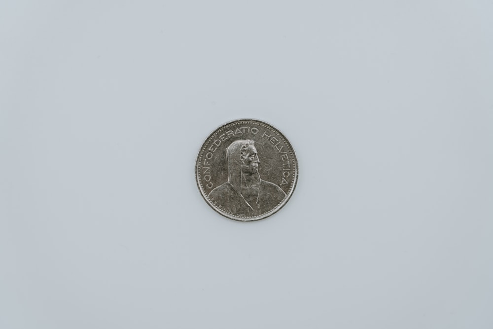 a close up of a coin on a white surface