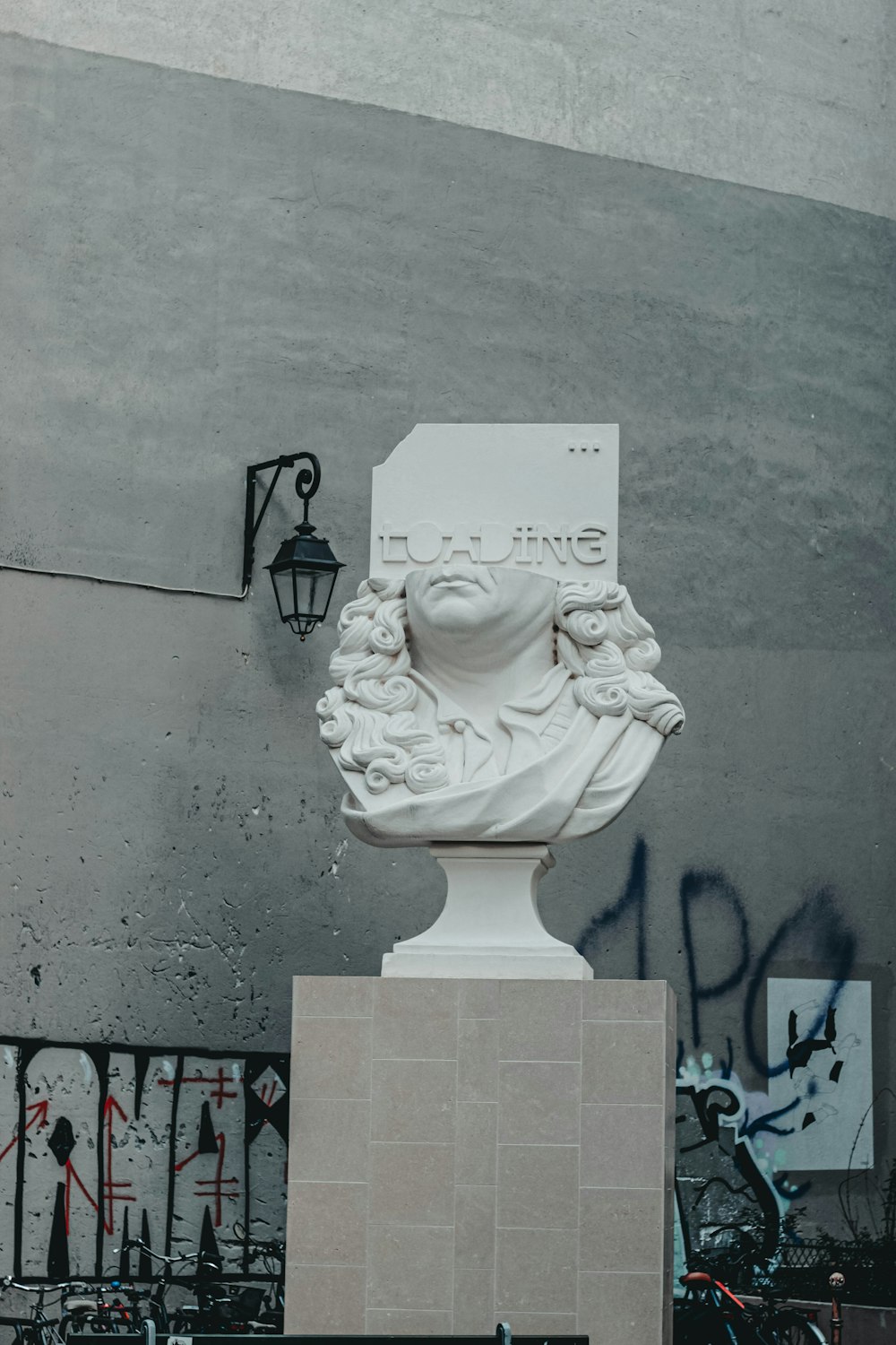 a statue of a bust of a man on a pedestal