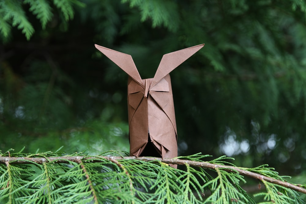 brown paper plane on green tree