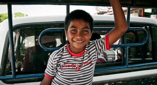 smiling boy in white and black striped crew neck t-shirt in Cabo de La Vela Colombia