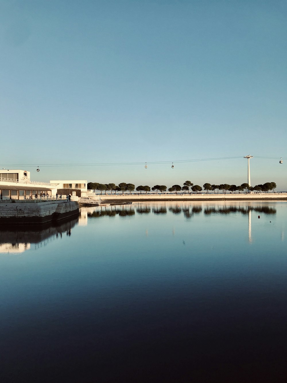 body of water near white concrete building during daytime