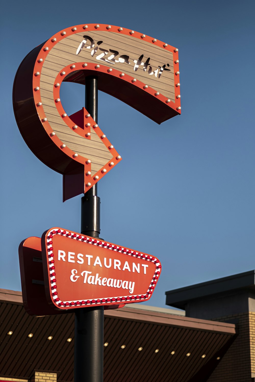 a restaurant and takeaway sign in front of a building