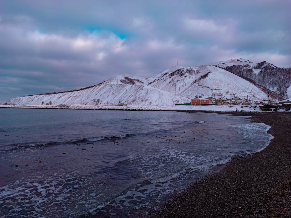 snow covered mountain under cloudy sky during daytime