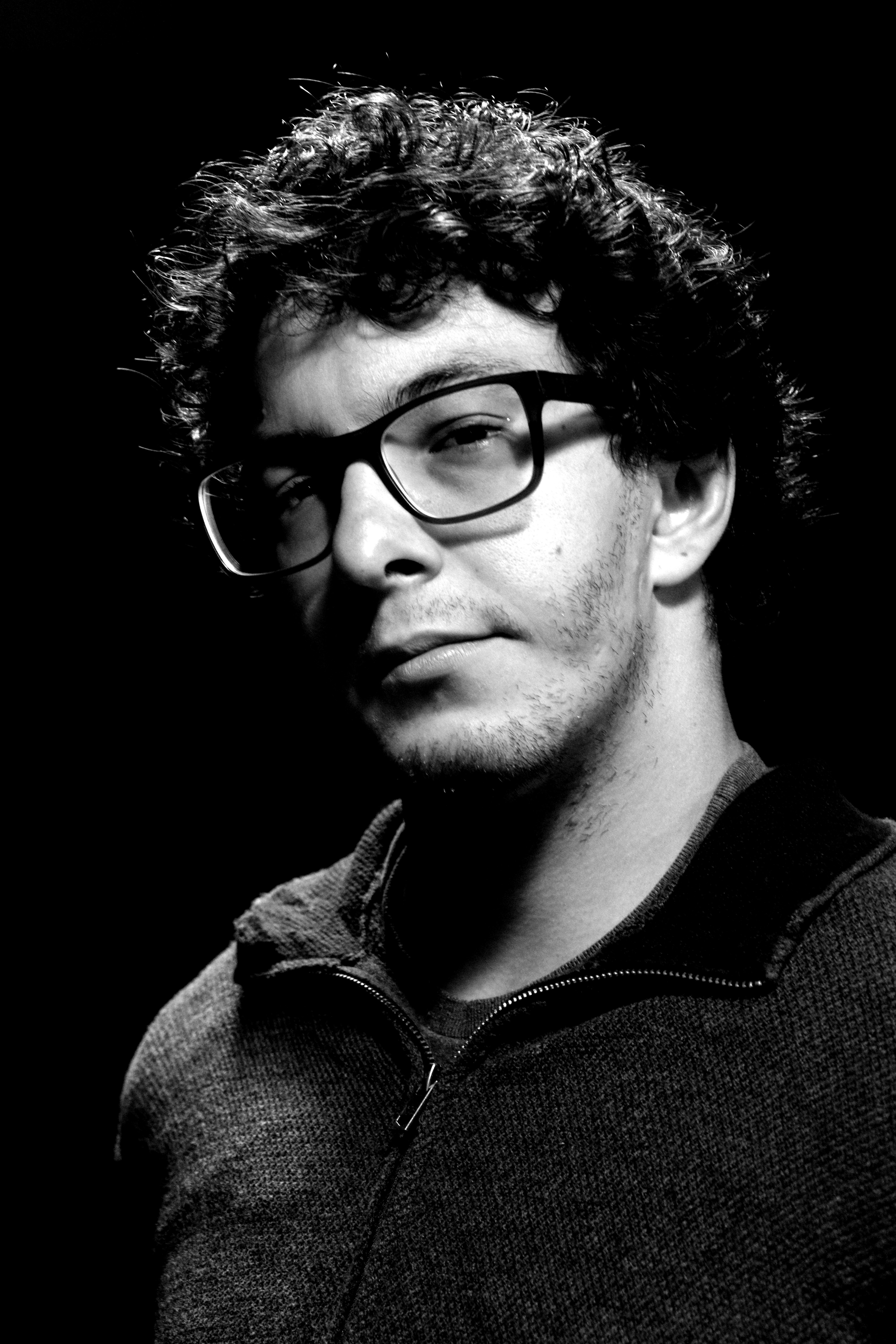 Profile photo of a man with glasses looking directly at camera
