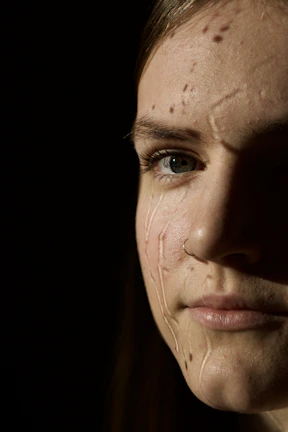 A close-up shot of an athlete’s focused expression, sweat glistening under dramatic lighting.