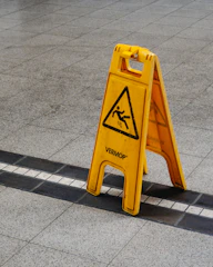 A slippery wet floor sign in a store, representing slip and fall incidents.