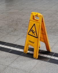 A person slipping on a wet floor inside a building, capturing the moment of the fall.