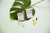 white and yellow medication pill on green leaf