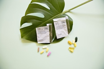 white and yellow medication pill on green leaf