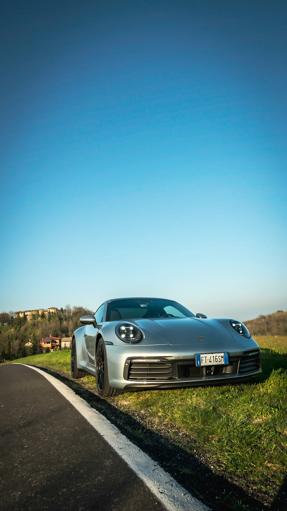 blue porsche 911 on road during daytime