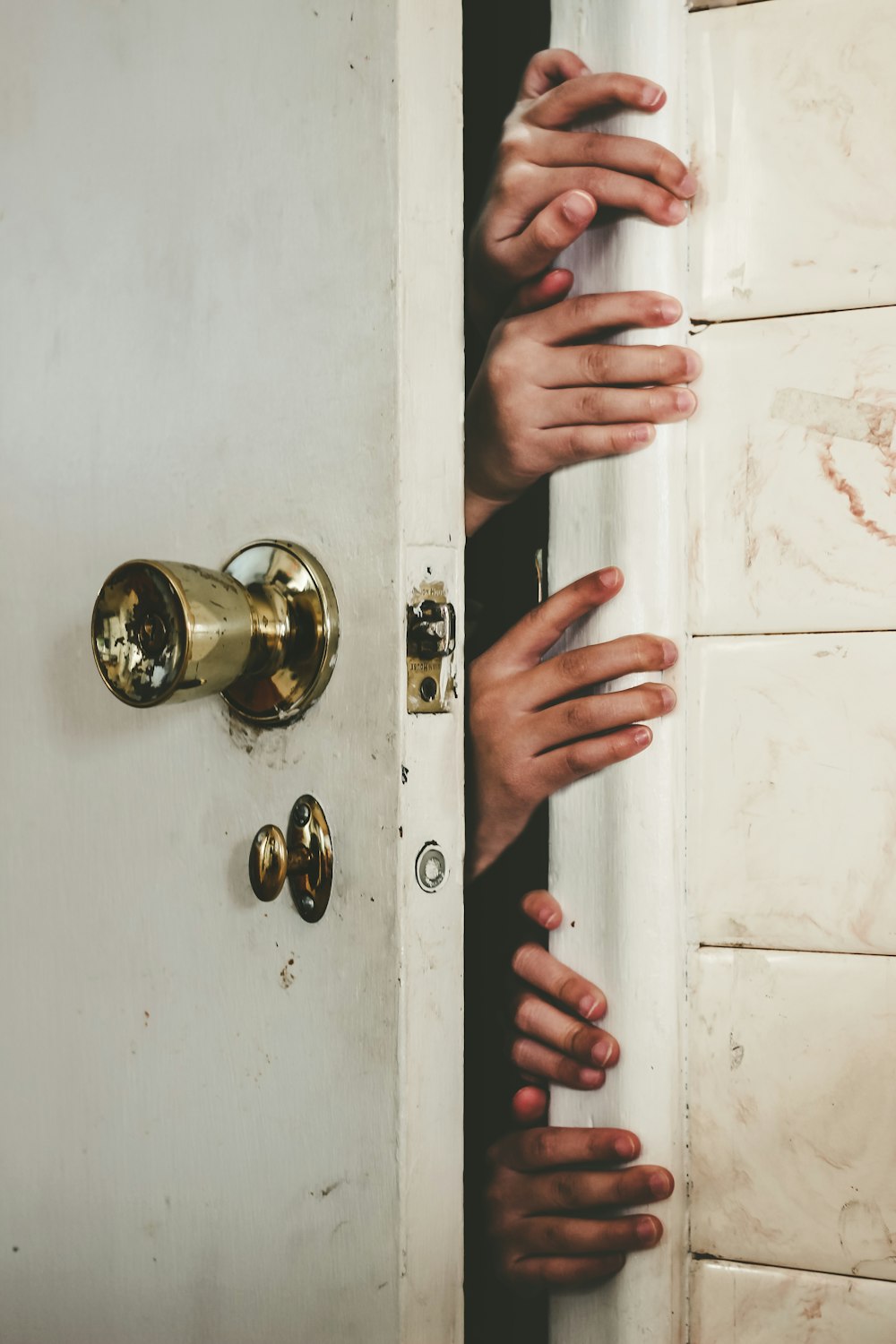 a group of hands reaching out of a door