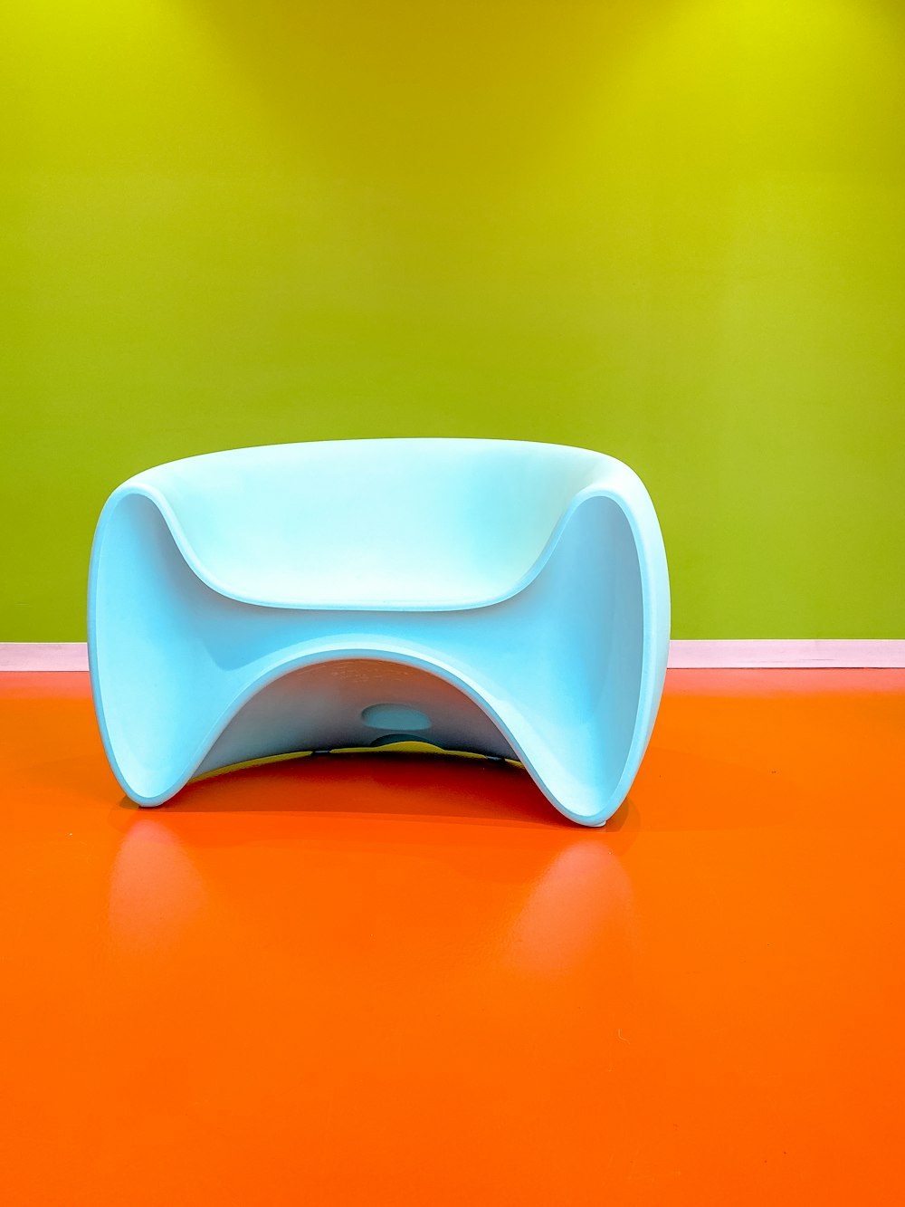 a blue table sitting on top of an orange floor