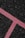 A textured black asphalt surface intersected by a bright pink line. The line is speckled with white granules, forming a distinct angular shape that stands out against the rough, dark background.