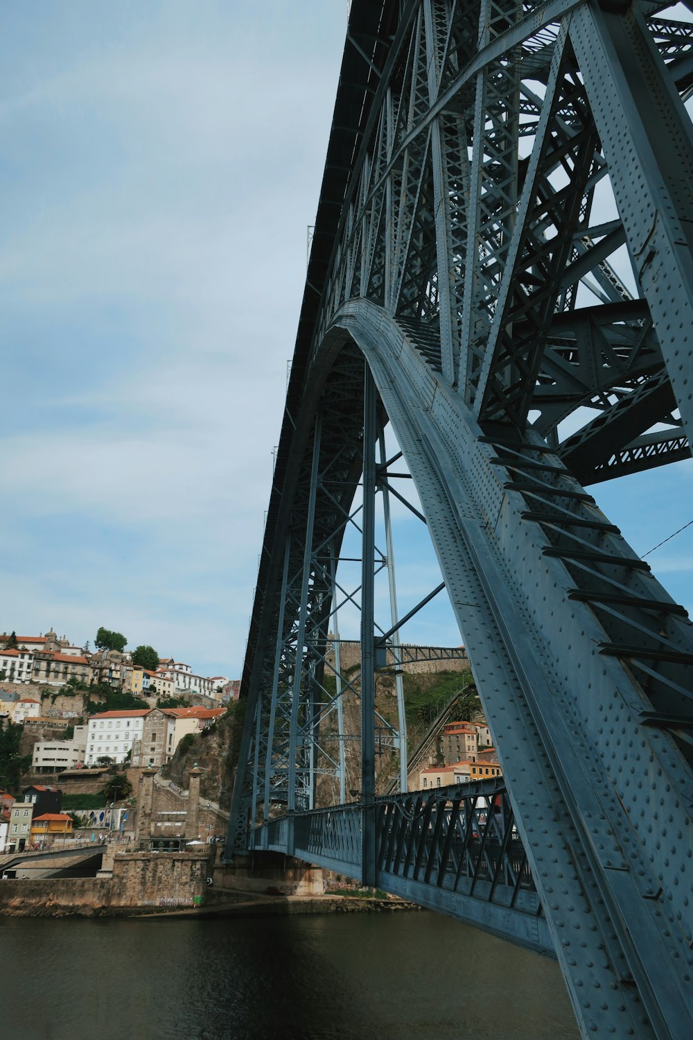 gray metal bridge over the city during daytime