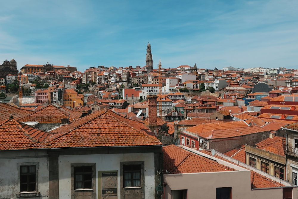 brown and white concrete houses under white clouds during daytime