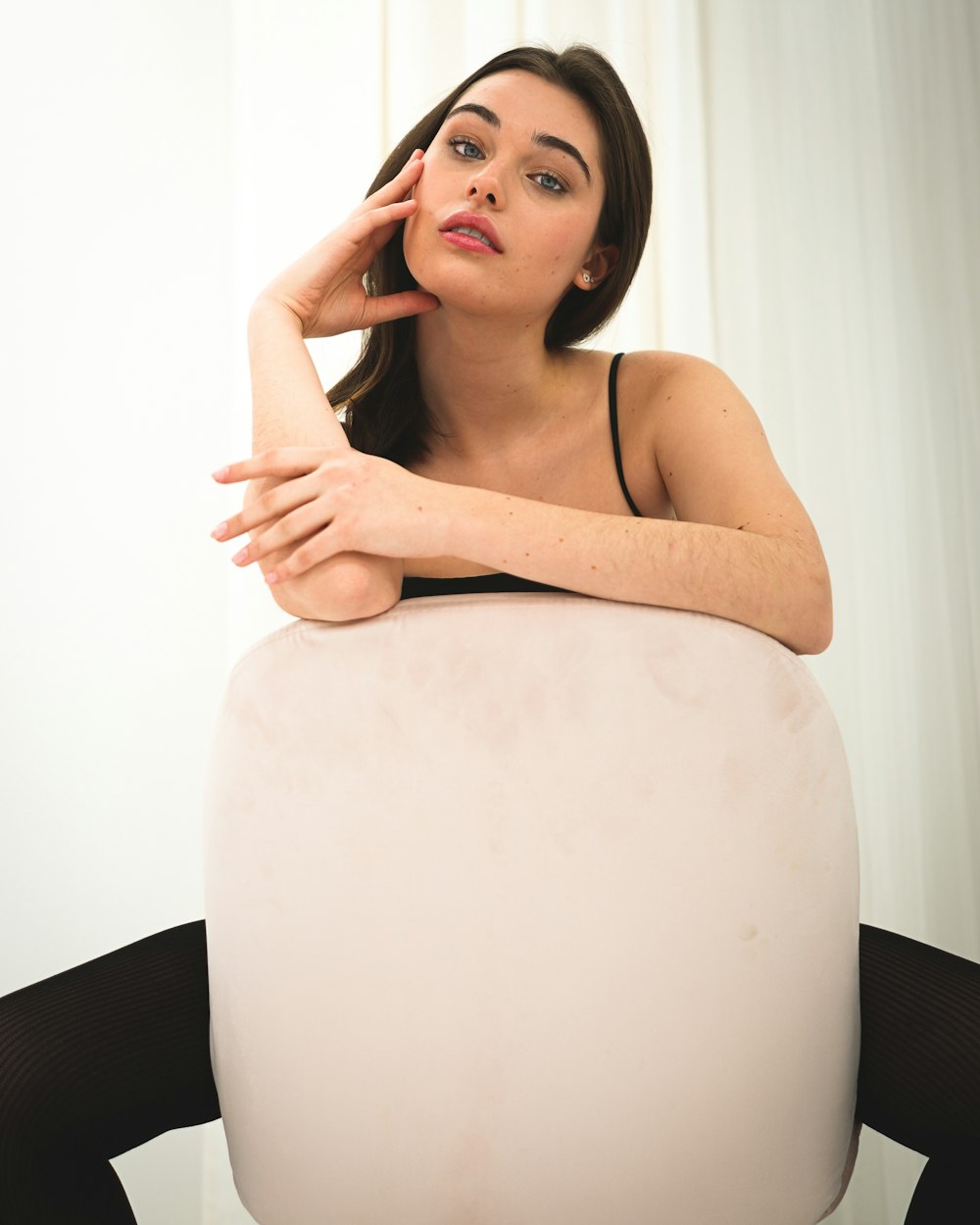 a woman sitting on top of a white object