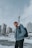 a man with a backpack standing in the snow