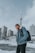 a man with a backpack standing in the snow